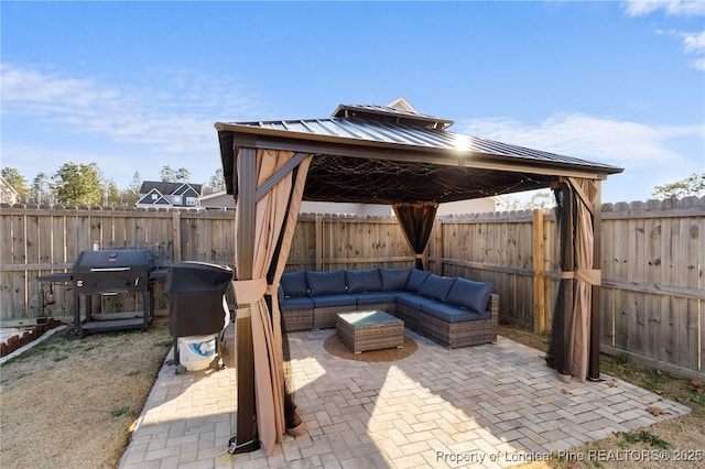 view of patio / terrace with a fenced backyard, an outdoor living space, area for grilling, and a gazebo