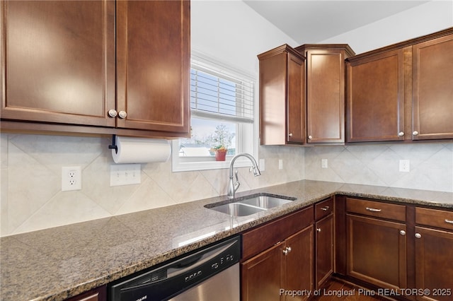 kitchen with tasteful backsplash, a sink, and dishwasher