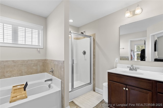 full bathroom with a stall shower, vanity, and a bath