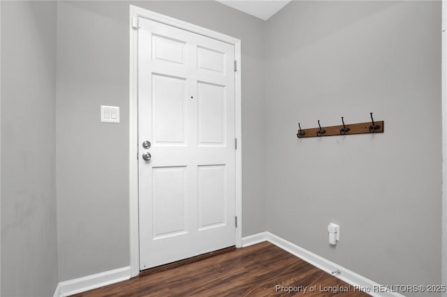 doorway to outside with baseboards and dark wood-type flooring