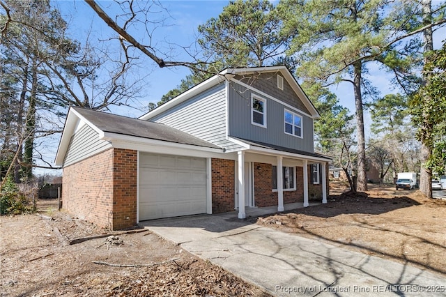 view of front of home with driveway, brick siding, a porch, and an attached garage