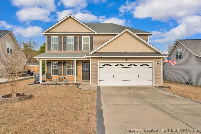 view of front of house with a porch, driveway, and a garage