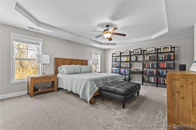 183 Ganton Dr, Raeford, NC 28376 - bedroom featuring visible vents, multiple windows, a raised ceiling, and baseboards