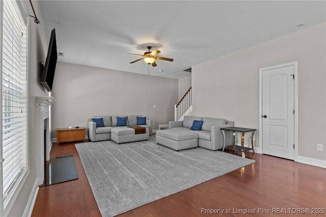 183 Ganton Dr, Raeford, NC 28376 - living area featuring a fireplace, baseboards, ceiling fan, and wood finished floors