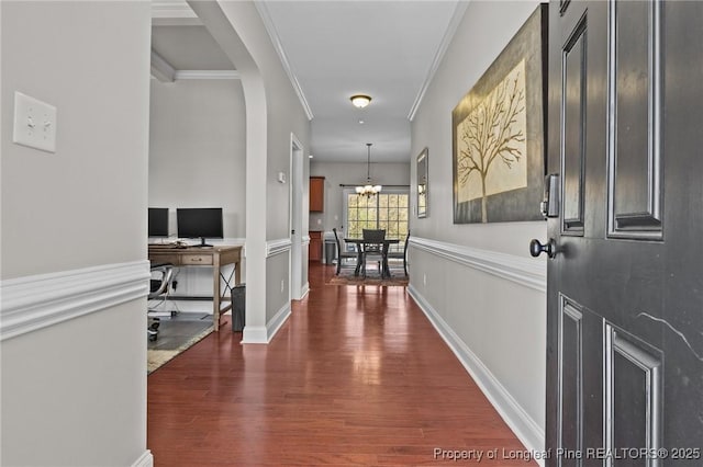183 Ganton Dr, Raeford, NC 28376 - hallway with a notable chandelier, dark wood-style floors, arched walkways, crown molding, and baseboards