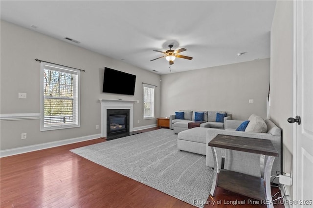 183 Ganton Dr, Raeford, NC 28376 - living room with visible vents, baseboards, ceiling fan, and wood finished floors