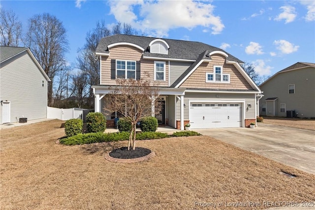 183 Ganton Dr, Raeford, NC 28376 - view of front of property with fence, driveway, roof with shingles, a porch, and an attached garage