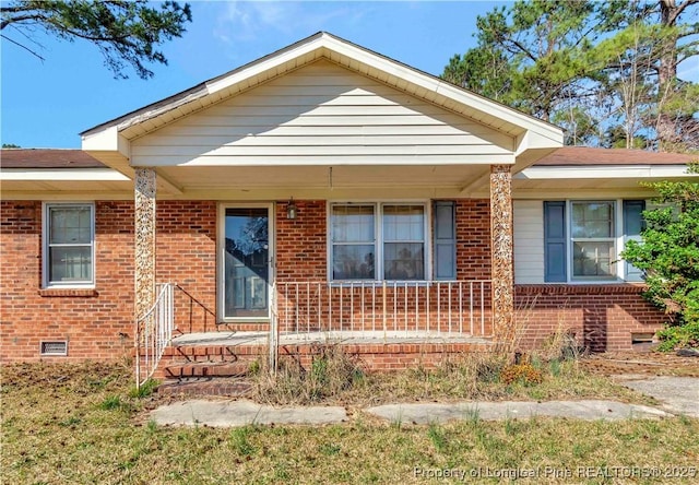 bungalow-style home with brick siding, crawl space, and a porch