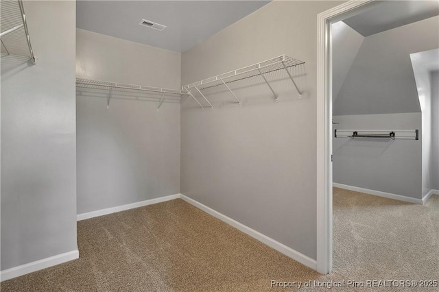 walk in closet with visible vents and carpet