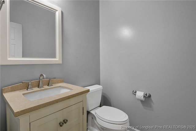 bathroom with toilet and vanity