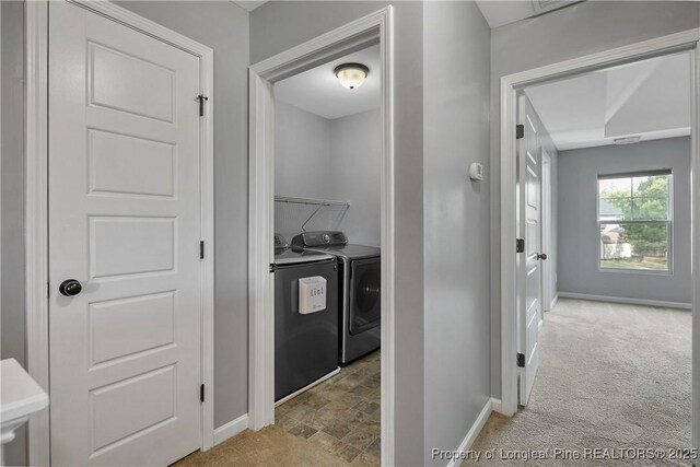 laundry room with carpet floors, baseboards, independent washer and dryer, and laundry area