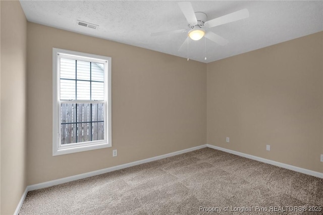 carpeted empty room with baseboards and ceiling fan