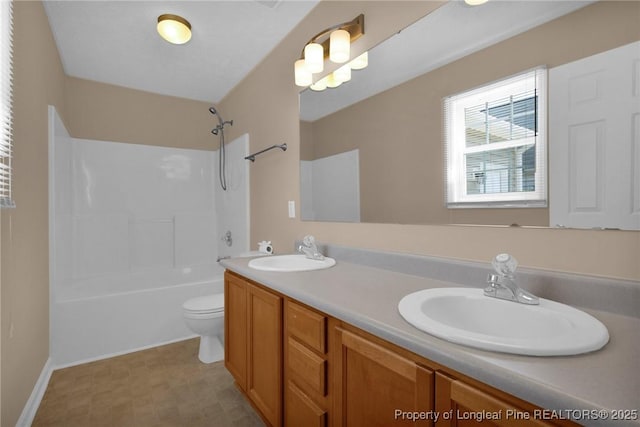bathroom featuring toilet, double vanity, and shower / washtub combination