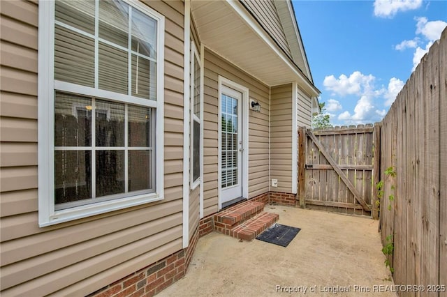property entrance with a gate and a patio area