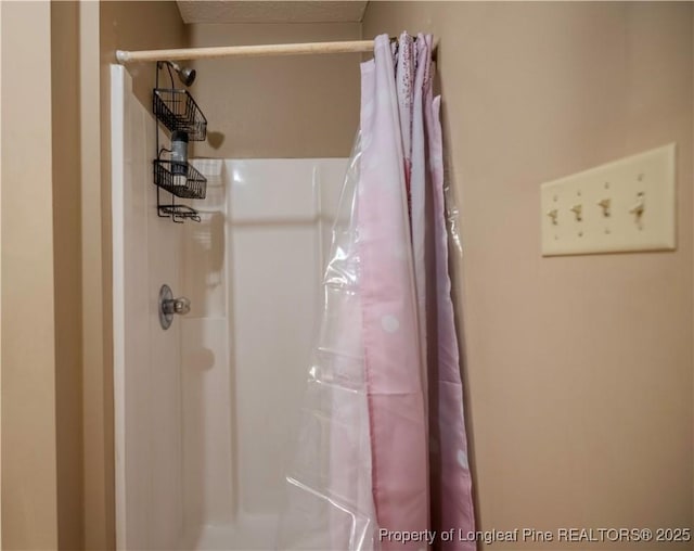 full bath with a shower with shower curtain