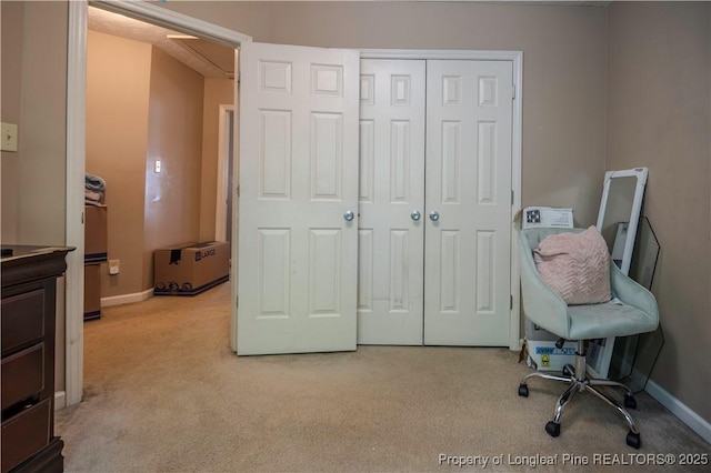 office area featuring baseboards and carpet