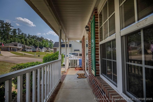 balcony with covered porch and a residential view
