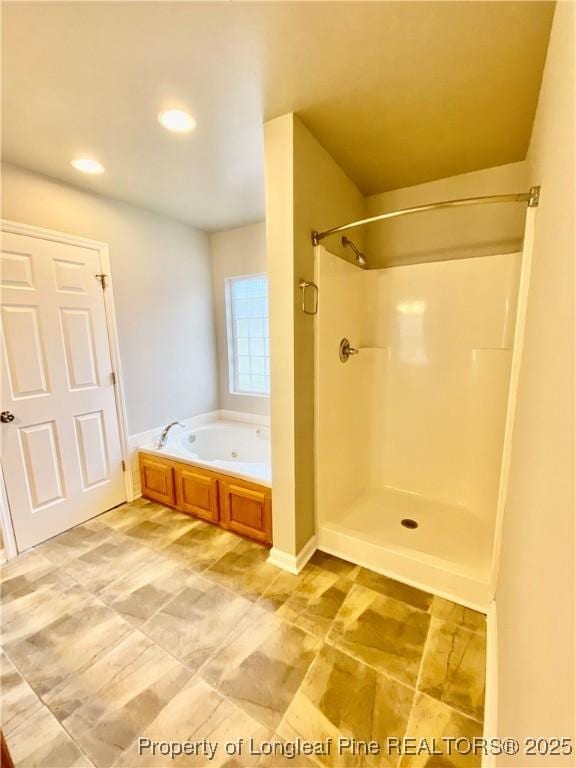 full bath featuring walk in shower, a garden tub, and recessed lighting