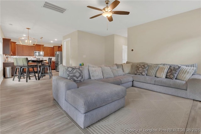 5145 Maxwell Rd, Stedman, NC 28391 - living area featuring ceiling fan, light wood finished floors, recessed lighting, and a chandelier