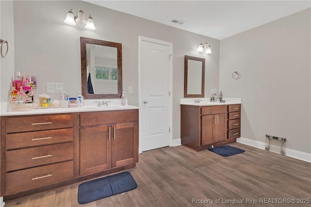 5145 Maxwell Rd, Stedman, NC 28391 - full bath with wood finished floors, two vanities, and baseboards