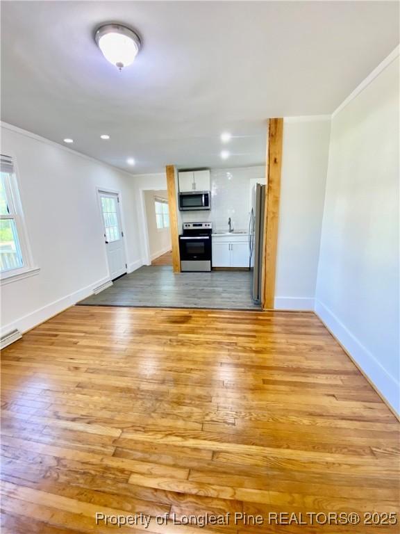 320 W 20th St, Lumberton, NC 28358 - unfurnished living room with ornamental molding, light wood finished floors, and recessed lighting