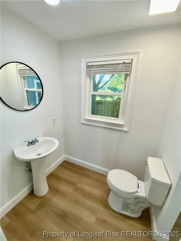 320 W 20th St, Lumberton, NC 28358 - half bathroom with toilet and wood finished floors