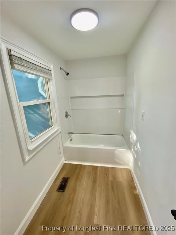 320 W 20th St, Lumberton, NC 28358 - full bathroom with wood finished floors and washtub / shower combination