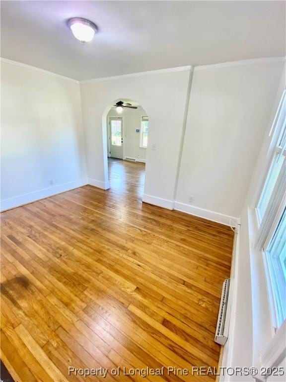 320 W 20th St, Lumberton, NC 28358 - spare room featuring light wood-type flooring, ornamental molding, and arched walkways
