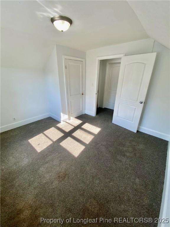 320 W 20th St, Lumberton, NC 28358 - additional living space featuring lofted ceiling and dark carpet