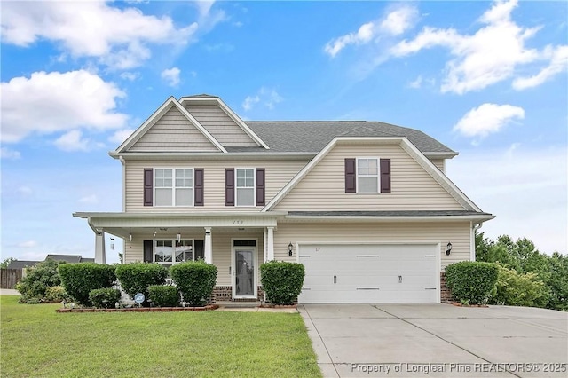 153 Dairy Ct, Raeford, NC 28376 - view of front of home featuring concrete driveway, a front lawn, a garage, and a porch