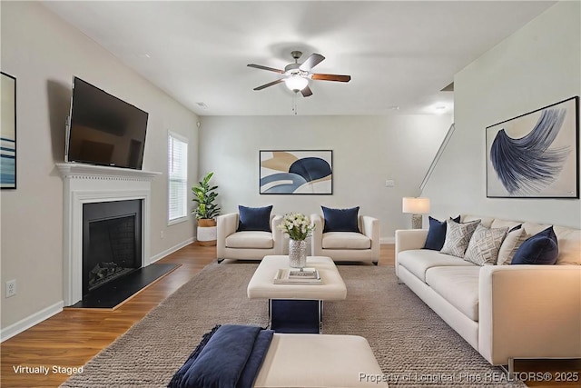 153 Dairy Ct, Raeford, NC 28376 - living area featuring a ceiling fan, wood finished floors, and a fireplace with raised hearth