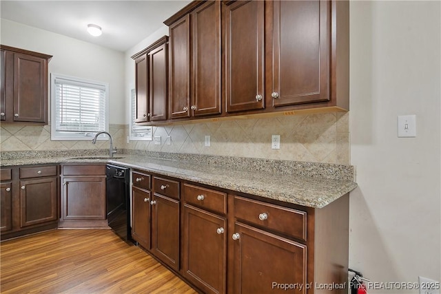 153 Dairy Ct, Raeford, NC 28376 - kitchen with dishwasher, tasteful backsplash, light wood-type flooring, light stone countertops, and dark brown cabinets