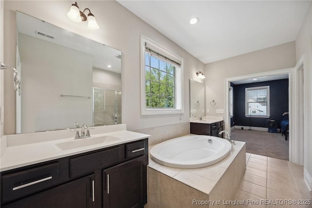 405 Gilpin Way, Cary, NC 27519 - full bathroom featuring a stall shower, plenty of natural light, a garden tub, two vanities, and recessed lighting