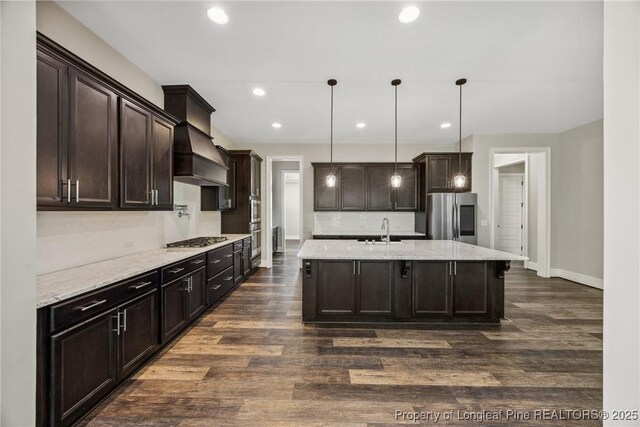 405 Gilpin Way, Cary, NC 27519 - kitchen with stainless steel appliances, a sink, dark brown cabinetry, dark wood finished floors, and recessed lighting