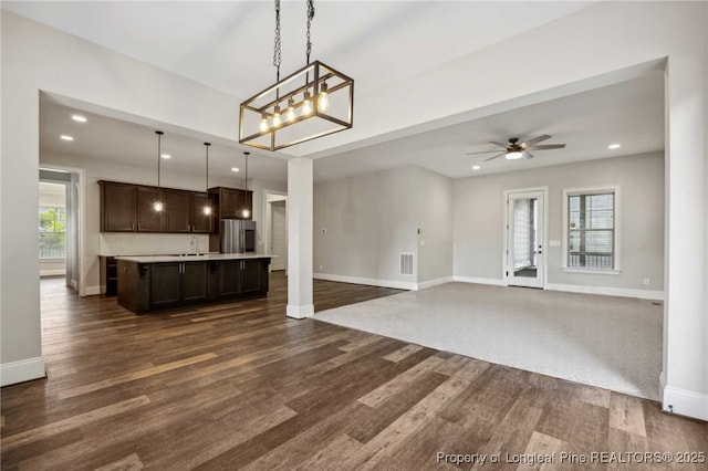 405 Gilpin Way, Cary, NC 27519 - kitchen featuring dark brown cabinetry, open floor plan, stainless steel refrigerator with ice dispenser, baseboards, and recessed lighting