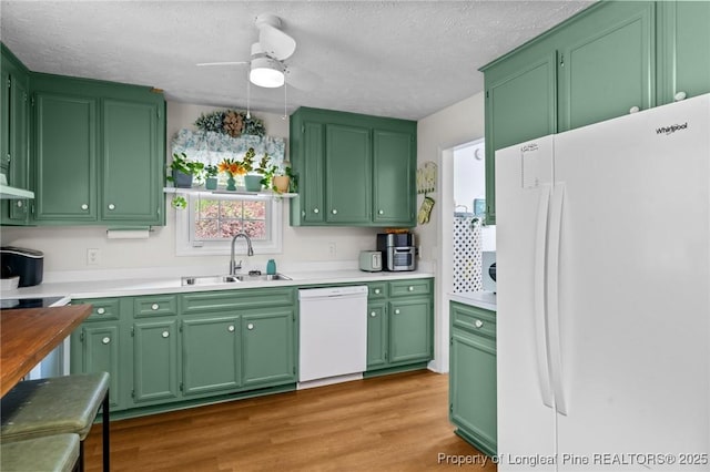 1963 Seabrook School Rd, Fayetteville, NC 28312 - kitchen with white appliances, a sink, light countertops, wood finished floors, and a ceiling fan