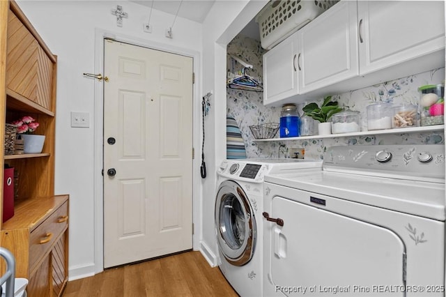 1963 Seabrook School Rd, Fayetteville, NC 28312 - laundry area featuring independent washer and dryer, light wood-style flooring, and cabinet space