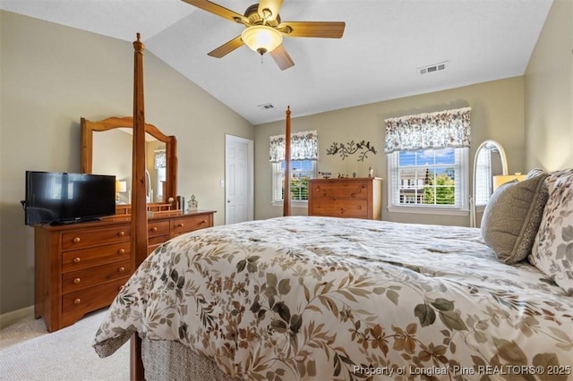 bedroom with light carpet, vaulted ceiling, a ceiling fan, and baseboards