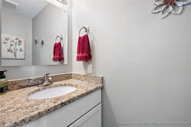 bathroom featuring vanity and a textured ceiling