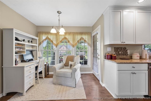 living area featuring baseboards, light wood-style flooring, an office area, and a chandelier