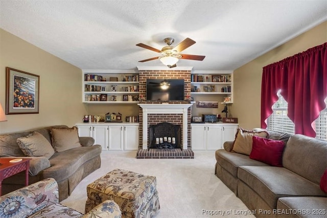 living room with light colored carpet, ceiling fan, a brick fireplace, and a textured ceiling