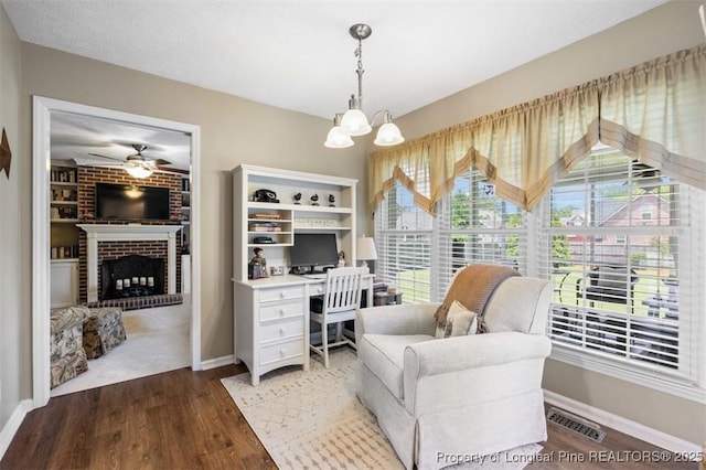 office with baseboards, a fireplace, and a chandelier