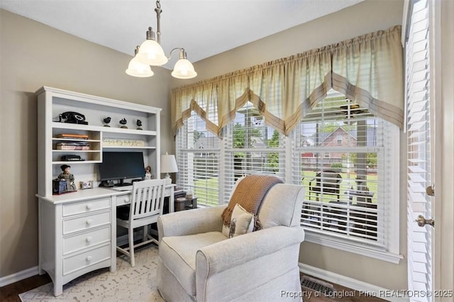 office space featuring baseboards and a chandelier