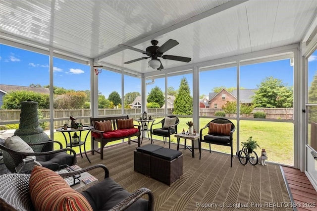 sunroom with ceiling fan and an outdoor living space