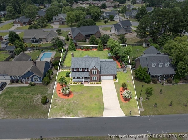 aerial view of residential area with a pool area