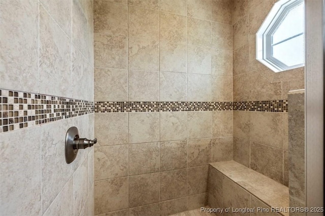 full bath with tiled shower