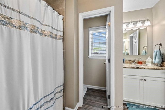 full bathroom featuring vanity, baseboards, wood finished floors, and a shower with curtain