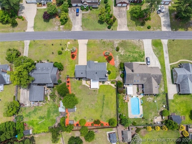 aerial overview of property's location featuring nearby suburban area and a pool