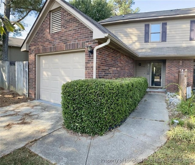 5566 Robmont Dr, Fayetteville, NC 28306 - traditional-style house featuring brick siding, a garage, and driveway