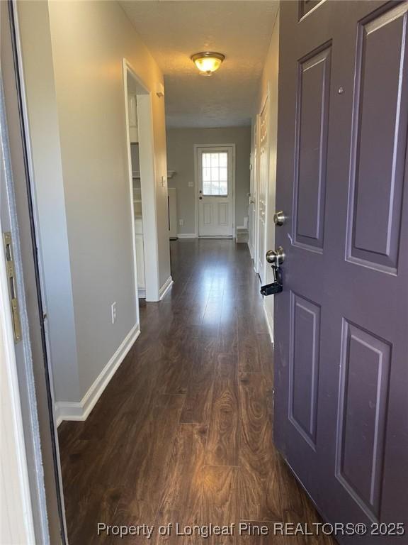 5566 Robmont Dr, Fayetteville, NC 28306 - entrance foyer with dark wood-style flooring and baseboards